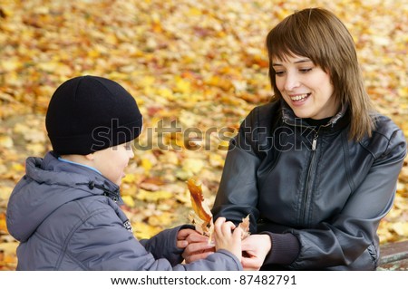 portrait of a cute mom with son at park
