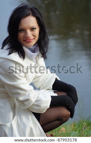 cute woman posing near the water in jacket