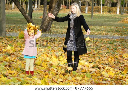 mom with her daughter playing at park