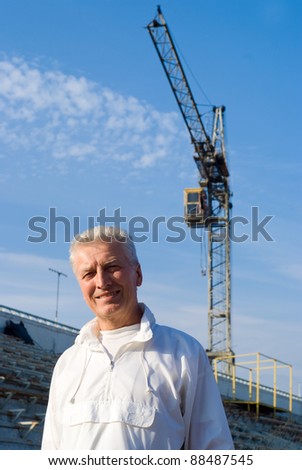 portrait of a pretty old man at construction