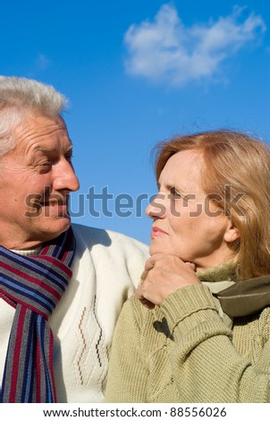 cute old couple posing with the sky on background