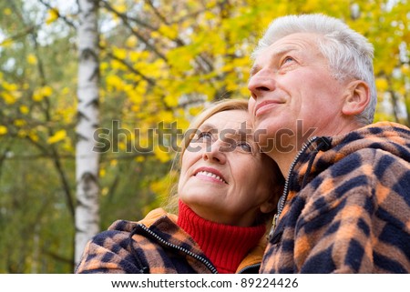 cute old couple posing in autumn park