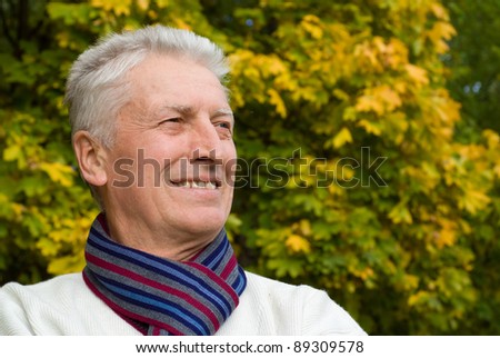 cute old man posing at autumn park