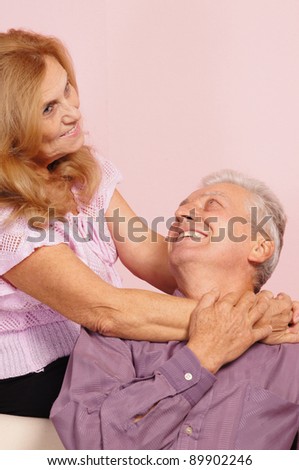 pretty old couple posing on a pink