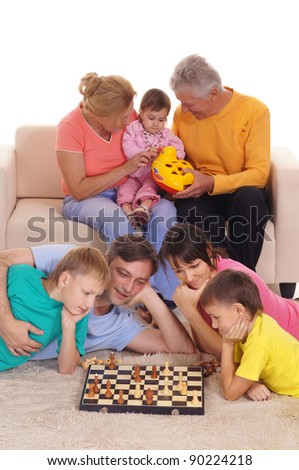 portrait of a big family playing chess