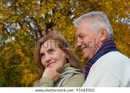 portrait of a pretty old couple posing at nature