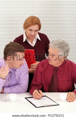 cute three business people sitting at table