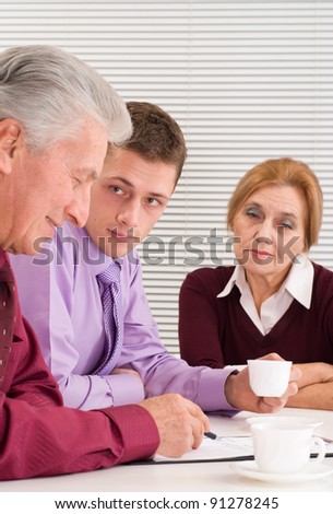 cute three business people sitting at table