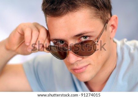 portrait of a cute young man in glasses