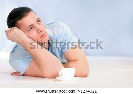 portrait of a cute young man with coffee