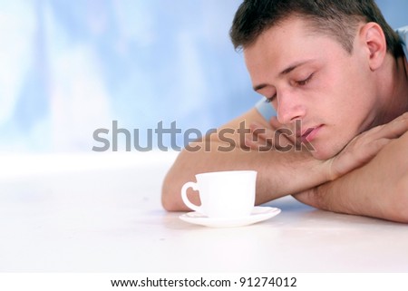 portrait of a cute young man with coffee