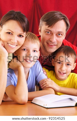 portrait of a parents and sons reading