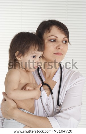 portrait of a cute doctor with little baby
