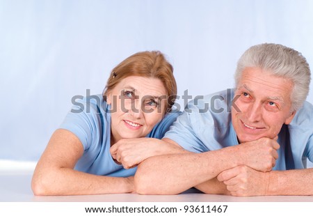 portrait of an aged couple lying at floor