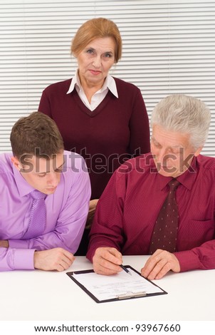nice three business people sitting at table