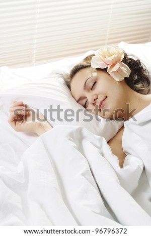 happy girl lying in bed on a white