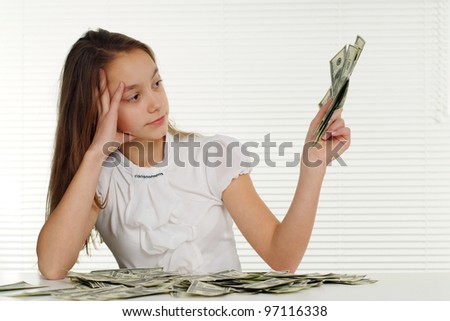 beautiful woman with money sits on a white background