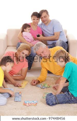 portrait of a big family playing on carpet