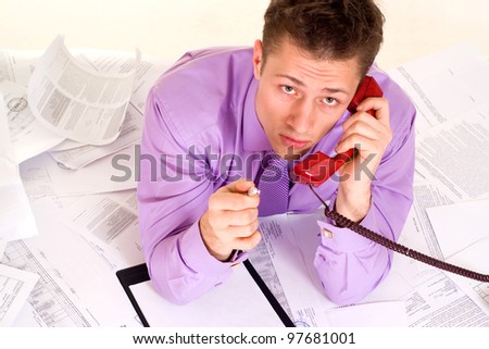 Handsome Caucasian nice Businessman very emotional on the phone on a light background