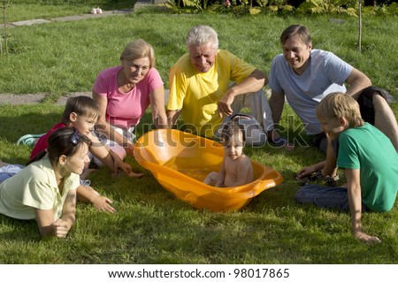 Caucasian nice good family of six people around a baby in nature