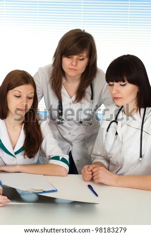 Three nice nurses view image on a light background