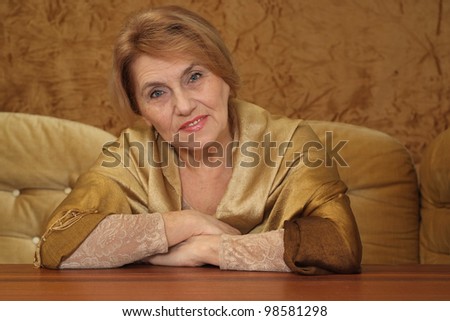 luck woman sitting on a sofa on a brown background