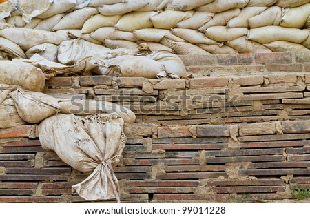 old sand bags on brick wall