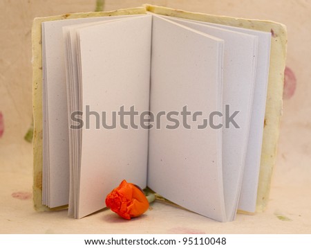 pad of paper with  empty  page and bud of poppy
