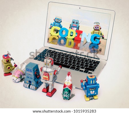 A team of robot toys learn coding on a laptop computer