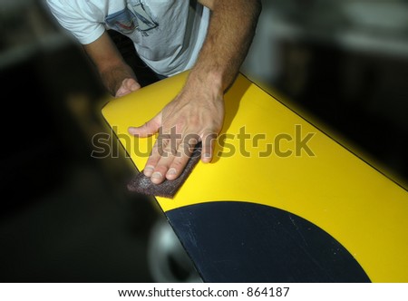 man waxing snowboard