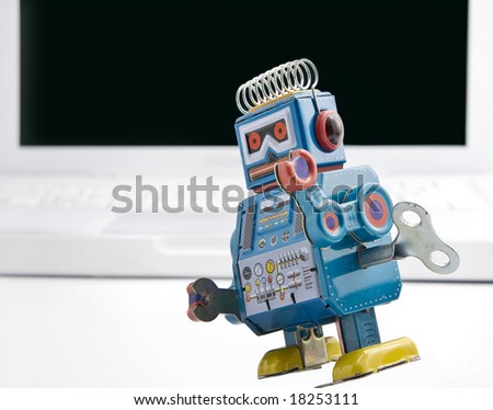 old retro robot toy and laptop