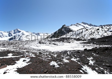 Mountain valley. Rocks, snow, stones and sky in Caucasus mountains. Elbrus area. \