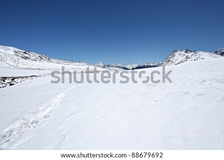 Snow surface of mountains against the blue sky . Elbrus area. Caucasus mountains.