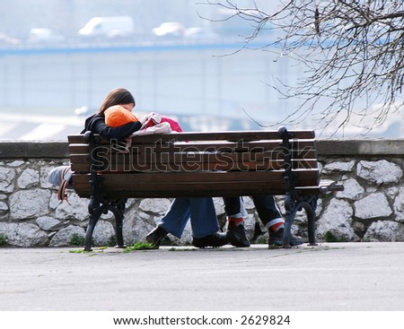 Young couple kissing on bench