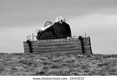 Young couple sitting on bench in park