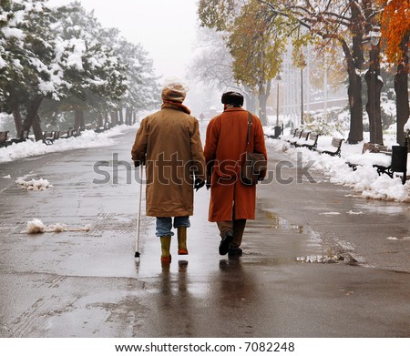 Older man walking at the park in November