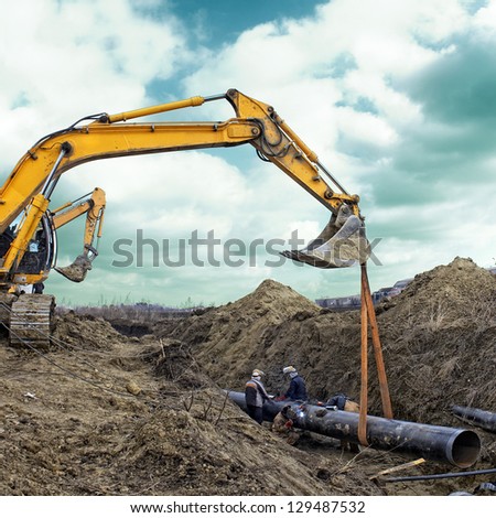 Construction site excavator wearing metal pipe Construction site excavator wearing metal pipe