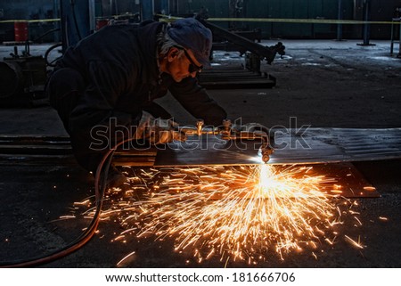 metal cutting with acetylene torch, focus on tools, low Light