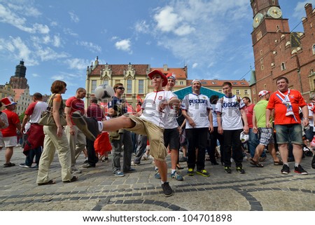 WROCLAW, POLAND - JUNE 8: Polish and Russian fans kicking ball in fanzone on June 8, 2012 in Wroclaw, Poland. Zone for the fans UEFA EURO Championship.