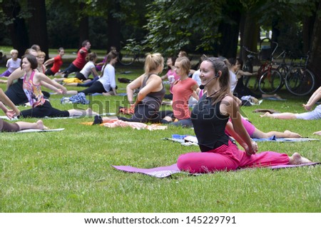 WROCLAW, POLAND - JULY 7: People practicing yoga in the park as part of \