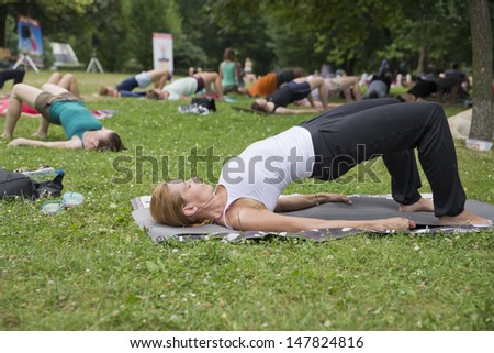 WROCLAW, POLAND - JULY 28: People practicing yoga in the park as part of \