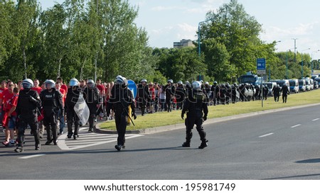 LUBIN, POLAND - MAY 31, 2014: fans of Widzew Lodz are escorted by the Police to the stadium  before match Polish Premier League between KGHM Zaglebie Lubin - Widzew Lodz.