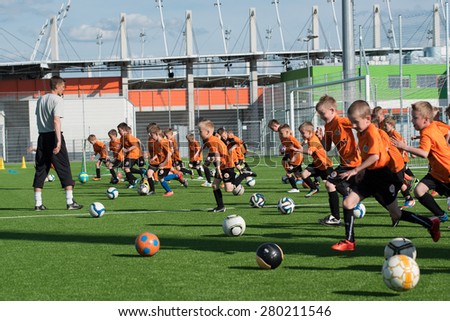 LUBIN; POLAND - MAY 15; 2015: Young players and trainer from football academy during the training. Football Academy KGHM Zaglebie is one of the biggest in Poland.