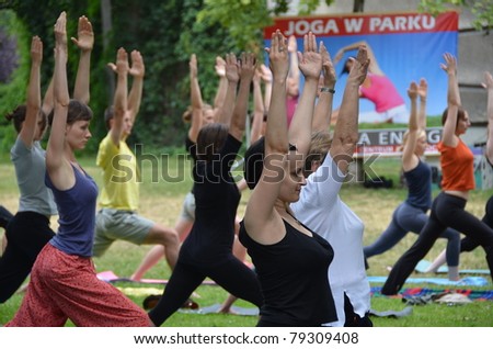 WROCLAW, POLAND - JUNE 12: Women practicing yoga in the park as part of \
