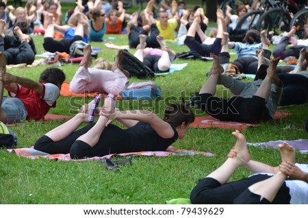 WROCLAW, POLAND - JUNE 12: People practicing yoga in the park as part of \