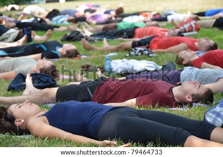 WROCLAW, POLAND - JUNE 12: Unidentified people relax after exercise yoga as part of \