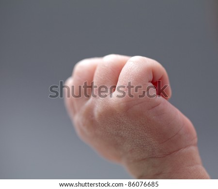Newborn baby hand in the air