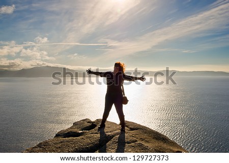 woman in Finisterre Cape in Galicia, Spain