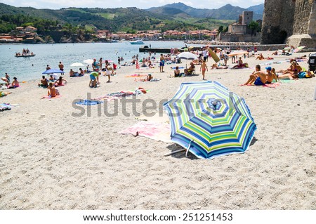 COLLIOURE, FRANCE - JULY  23: Tourists relax in the beach in the small village of Colliure, south France on July 23, 2014 in Collioure, France.