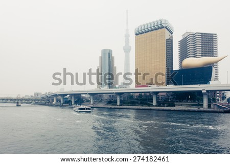 TOKYO, JAPAN - MARCH 19: Tokyo Skytree and Asahi Beer Hall  along the Sumida River on March 19, 2015 in Tokyo, Japan.